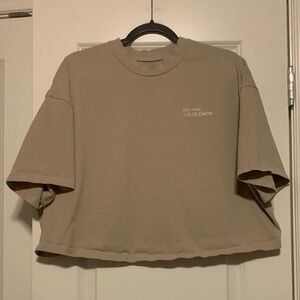 Lululemon Beige Logo Crop Tee, size 12
Good Condition